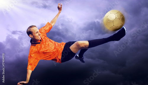 Shoot of football player on the sky with clouds © Andrii IURLOV