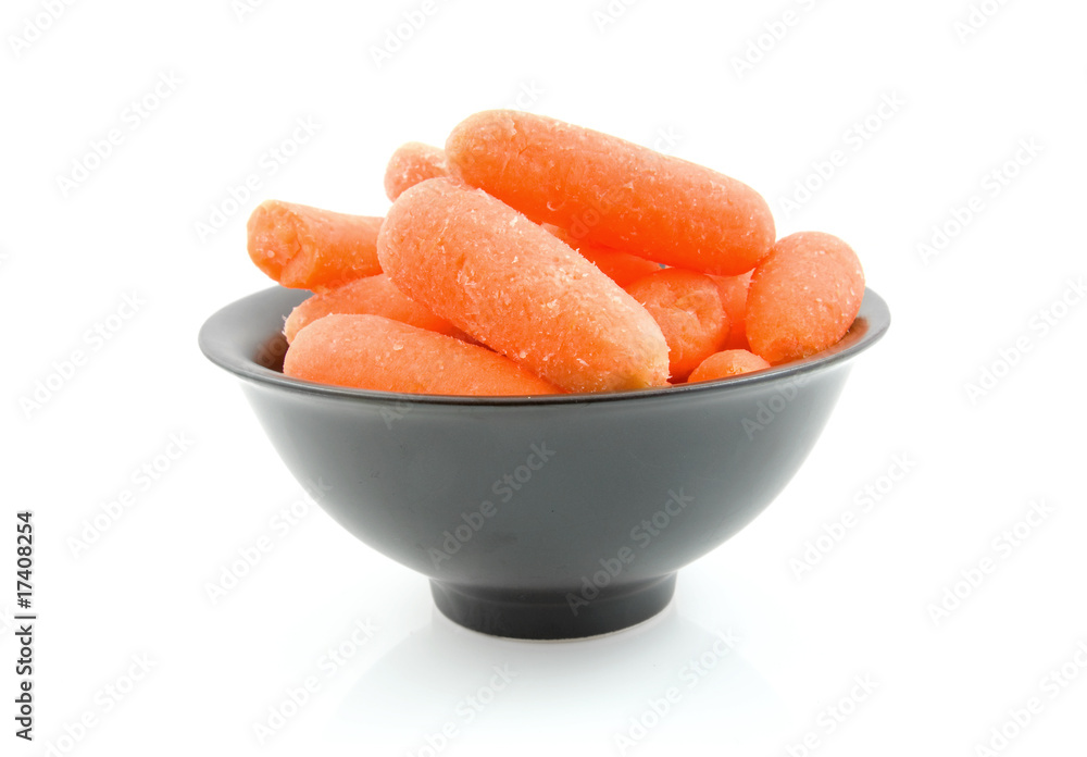 fresh raw carrots in black bowl over white background fresh raw carrots in black bowl over white background
