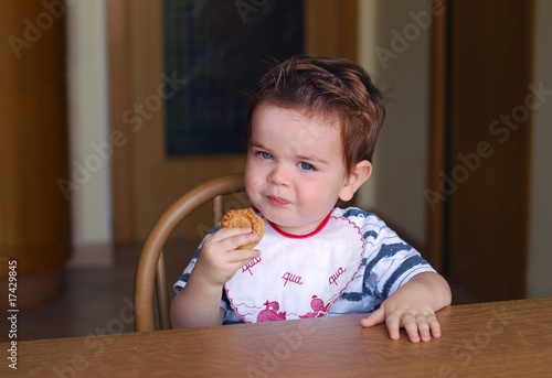 A little boy eating a cookie