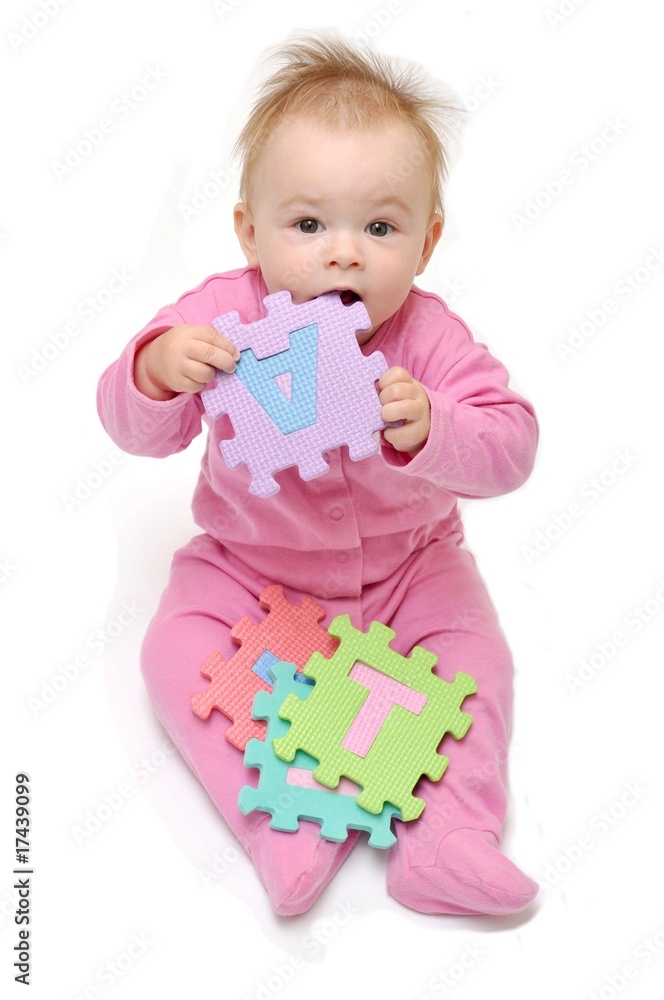 child playing multi colored alphabet puzzle child playing multi colored alphabet puzzle