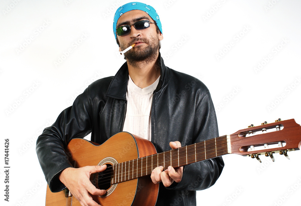 Obraz premium young guy in dark glasses and bandana, with a guitar