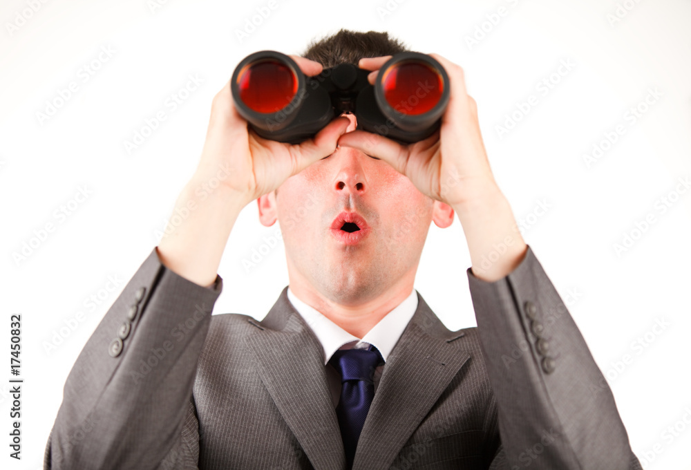 Young businessman looking through binoculars Young businessman looking through binoculars