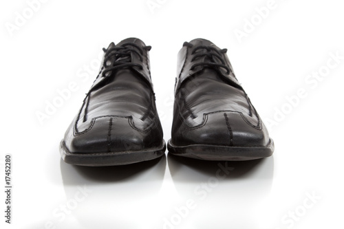 Men's black dress shoes on a white background