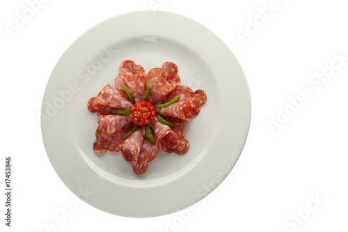 salami on white plate isolated
