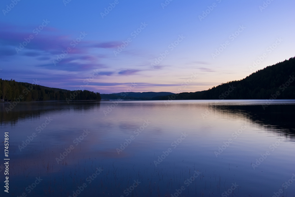 Blue cold sunrise over lake in sweden