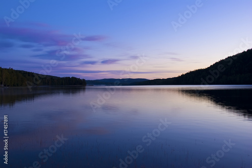Blue cold sunrise over lake in sweden