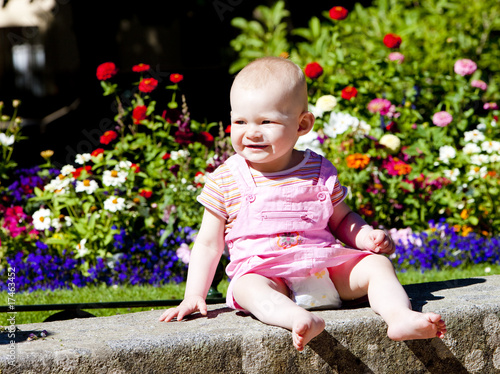 baby girl sitting in the garden