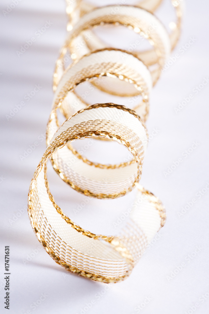 Fototapeta premium Golden curls ribbons on a white background