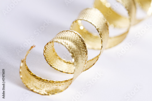 Golden curls ribbons on a white background