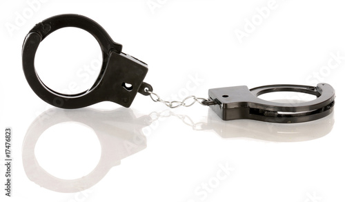 toy handcuffs with reflection on white background