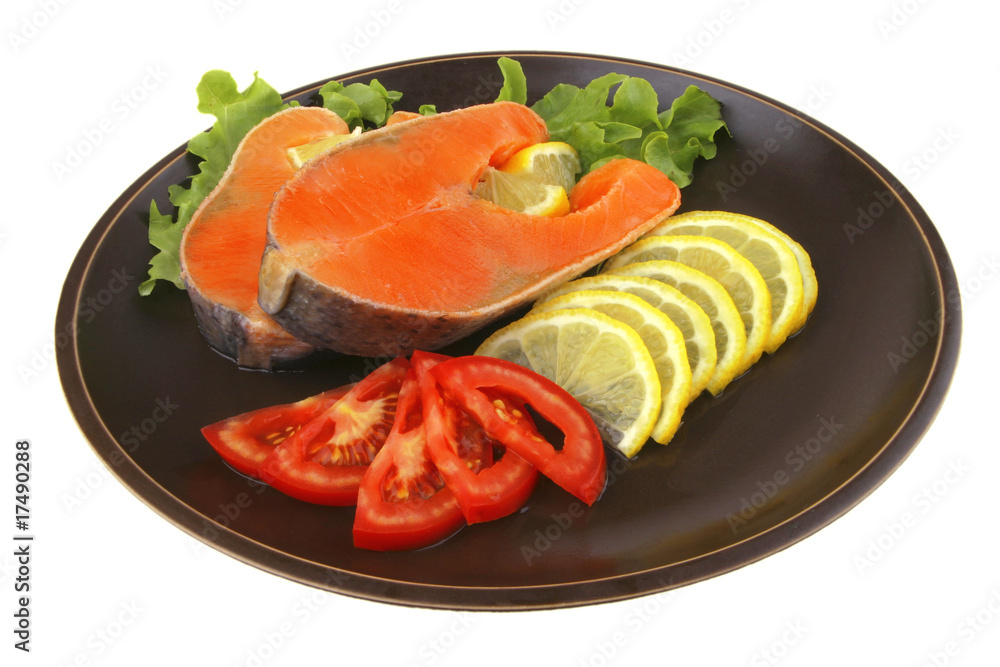 two salmon steak on dark dish two salmon steak on dark dish