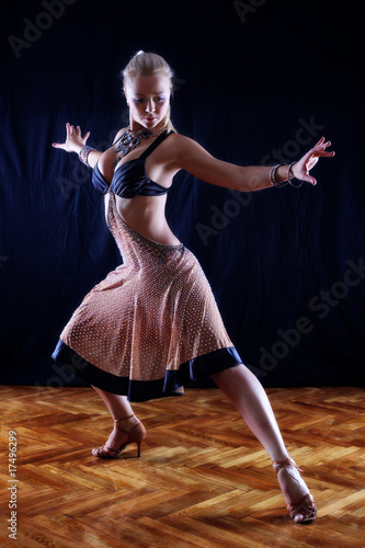 dancer in ballroom against black background