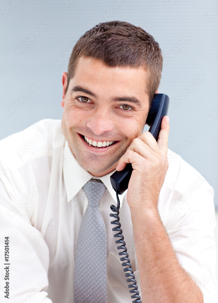 Attractive businessman on phone in office Attractive businessman on phone in office