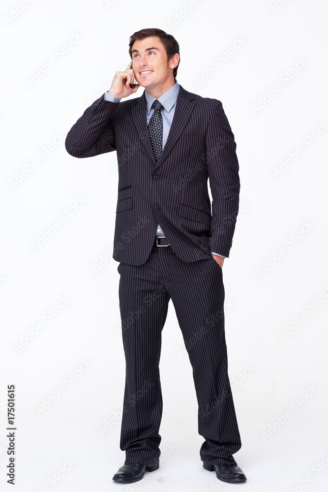 Attractive businessman on mobile phone against white Attractive businessman on mobile phone against white