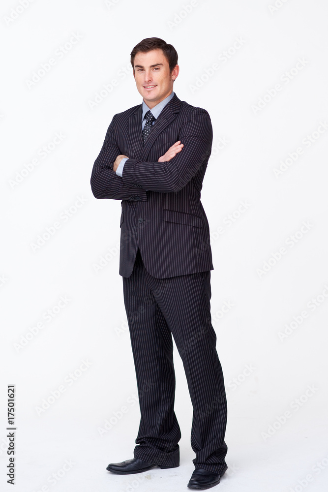 Confident businessman with folded arms against white Confident businessman with folded arms against white