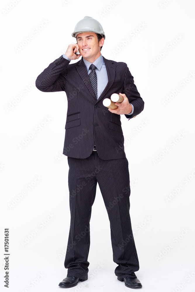 Attractive architect on mobile phone holding plans Attractive architect on mobile phone holding plans