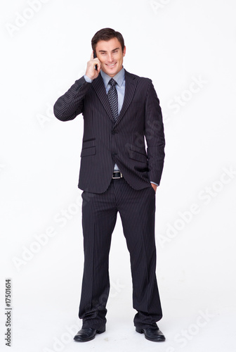 Attractive businessman on phone against white