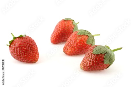 Four strawberries over white background
