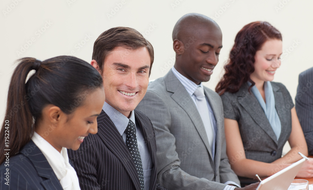 Smiling businessman working in a meeting Smiling businessman working in a meeting