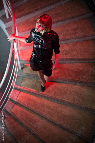 young woman walking down the stairs of a nightclub