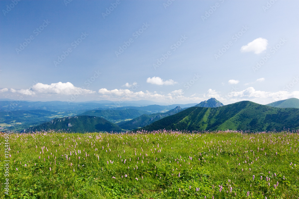 Obraz premium Mountain-ridge and blue sky with white clouds