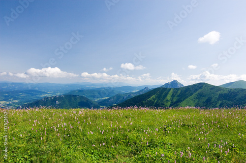 Mountain-ridge and blue sky with white clouds