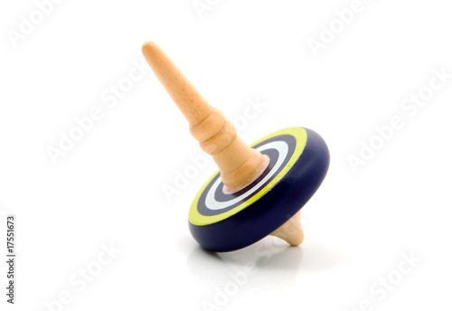 Fotografija Blue spinning top over white background