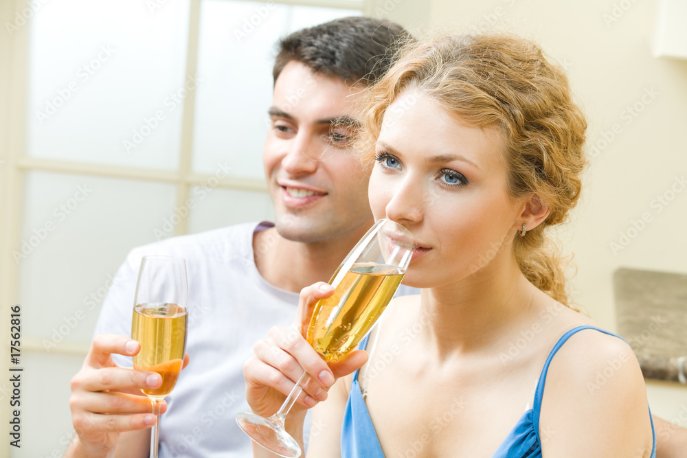 Young couple celebrating with champagne at home Young couple celebrating with champagne at home