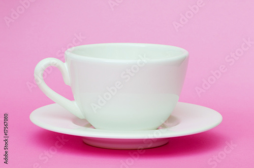 White cup isolated on the pink background