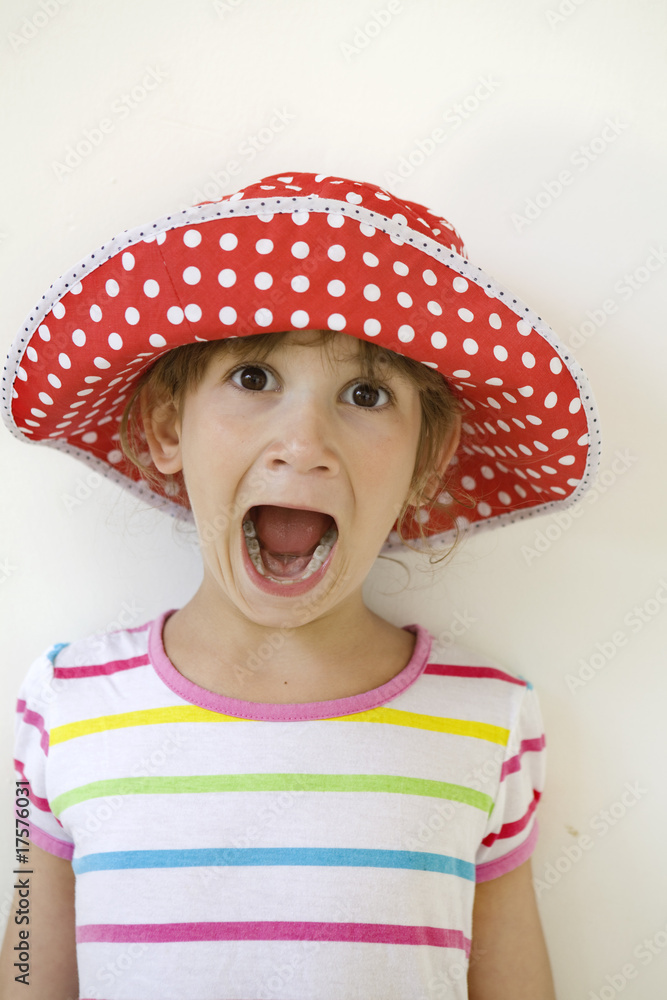 funny girl in spot red panama shouting near white wall funny girl in spot red panama shouting near white wall