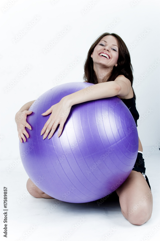 Young woman on white background in a fitness pose Young woman on white background in a fitness pose