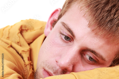 Close-up portrait of young and sad boy, studio shot