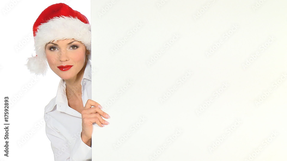 Girl in santa claus hat holding empty board Girl in santa claus hat holding empty board