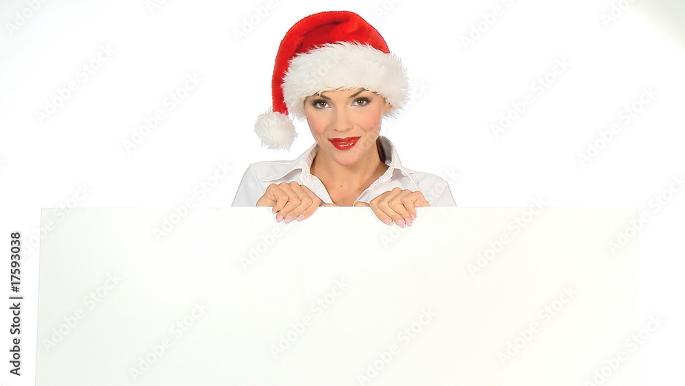 Girl in santa claus hat holding empty board