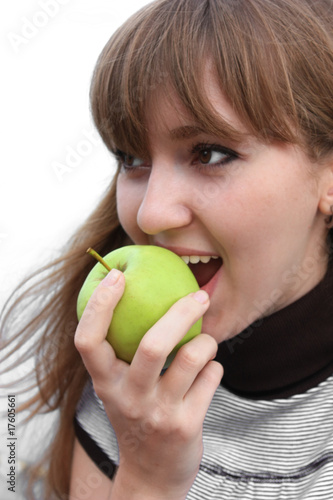 young woman eating green apple