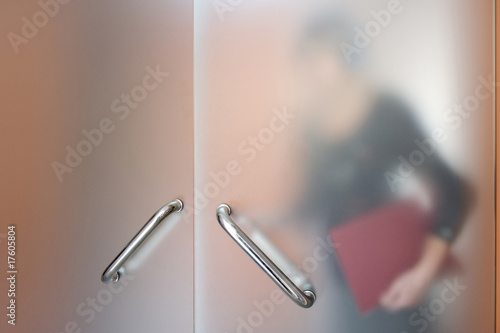 Blurry silhouette of businesswoman going to boss