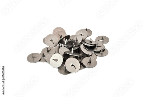 Some classic metal thumbtacks on a white background