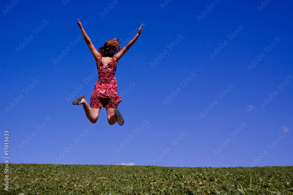 Woman jumping for joy on a green hillside! Woman jumping for joy on a green hillside!