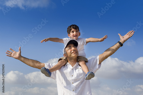 child on man shoulders