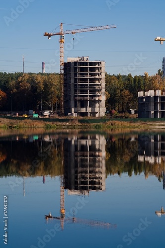 Crane and building reflection in the lake