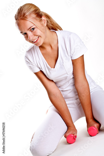 pink dumbbells in the hands of women