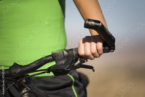 Hand on bike handlebar