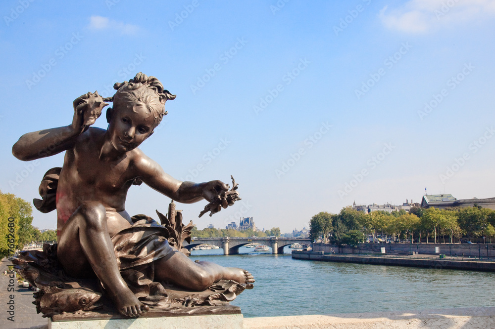 Small child statue frames view of Seine and Paris