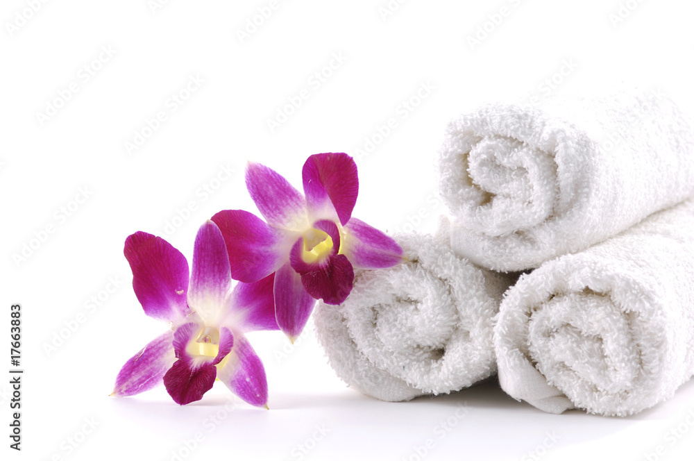 White rolled up towel with pink orchid White rolled up towel with pink orchid