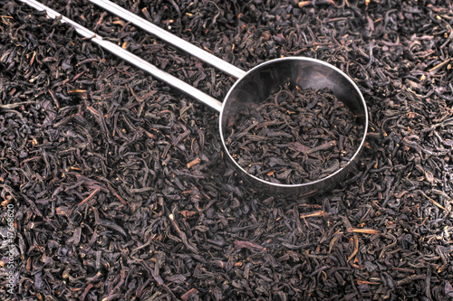 Spoon and dried tea leaves photo