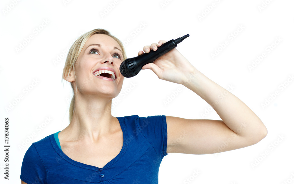 Woman singing on a microphone against white background Woman singing on a microphone against white background