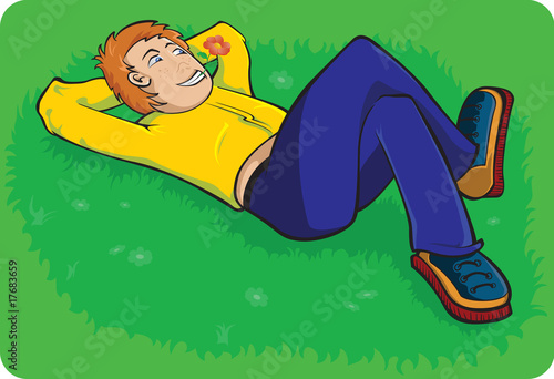 Boy lay down on summer grass