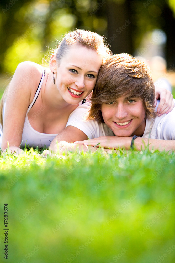 Couple lying down on grass Couple lying down on grass