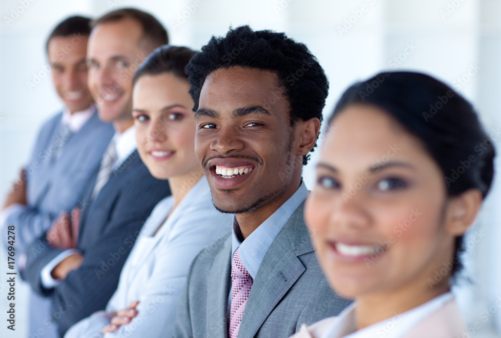Attractive businessman in a row with his team Attractive businessman in a row with his team