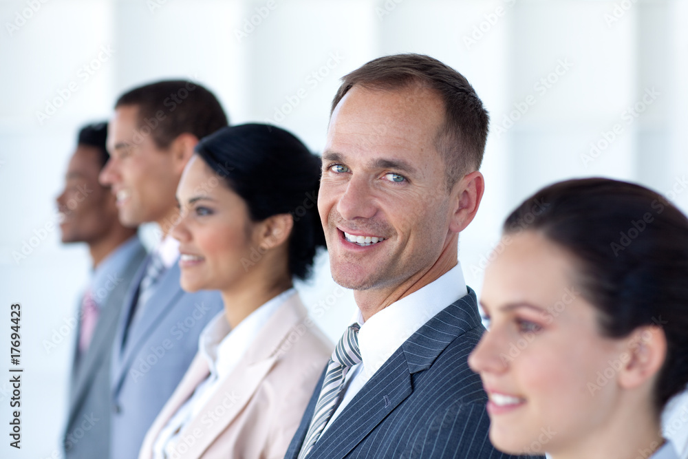 Attractive businessman in a row with his team Attractive businessman in a row with his team